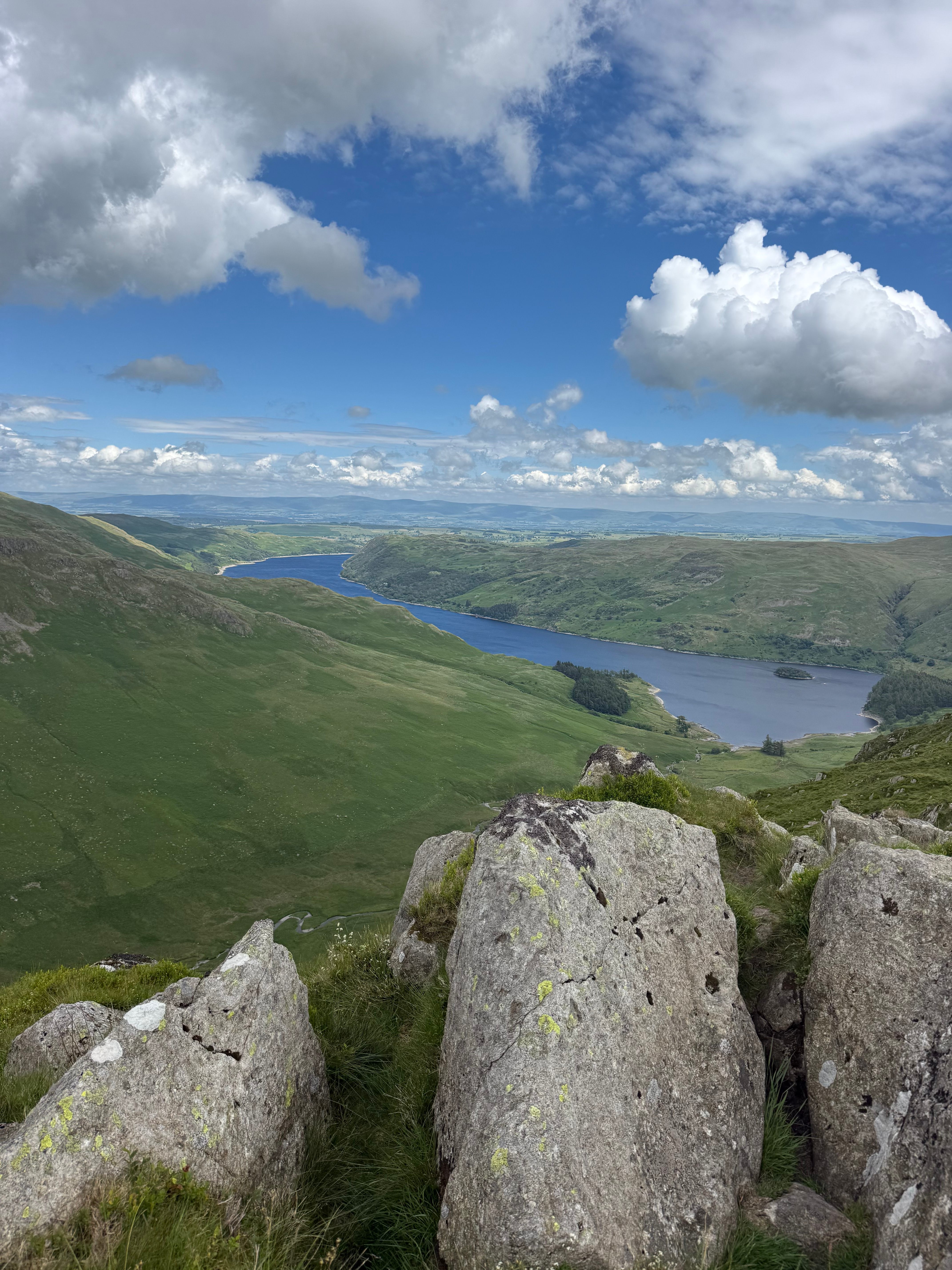 Panoramic view over a Lake District reservoir winding through green valleys